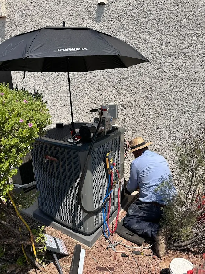 HVAC technician performing outdoor AC maintenance in Cheyenne